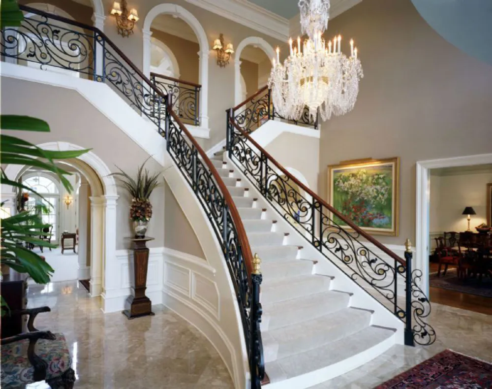 White stair with glass balustrade and Chihuly glass chandelier